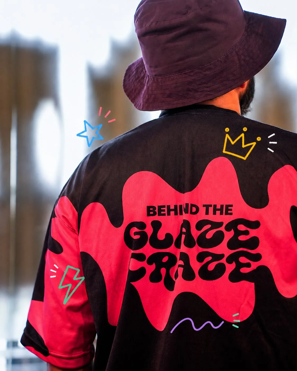 The back of the staff tee: a pink glaze shape with 'Behind the Glaze Craze' running across the back and onto the sleeves